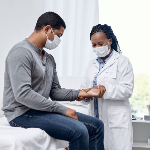 Shot of a doctor checking a patient's pulse
